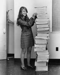 Hamilton in 1969, standing next to listings of the software she and her MIT team produced for the Apollo project