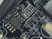 Surface mount components, including resistors, transistors and an integrated circuit.